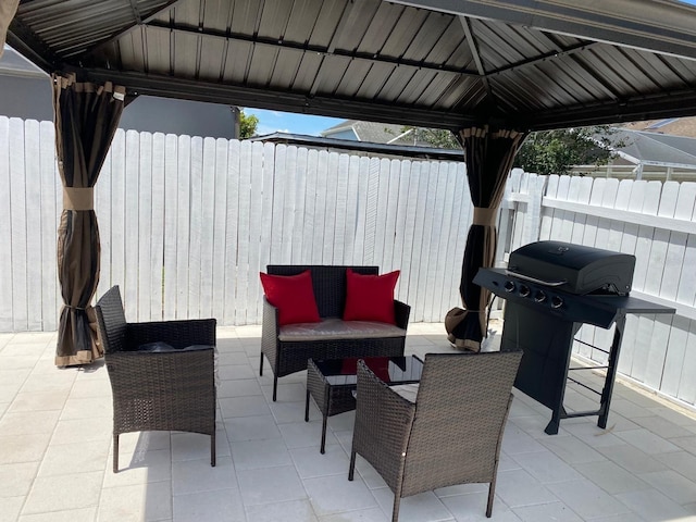 view of patio featuring a gazebo, a grill, and outdoor lounge area