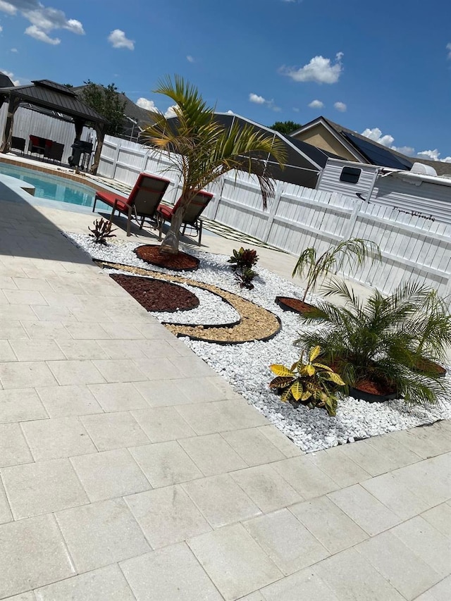 view of swimming pool featuring a gazebo and a patio area