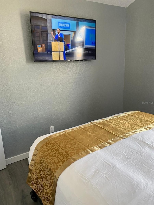 bedroom with hardwood / wood-style floors