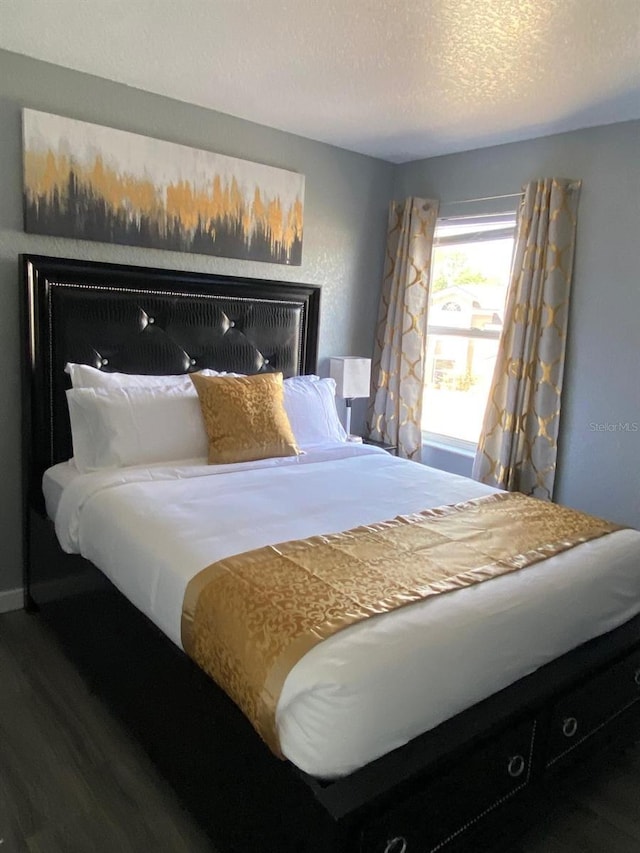 bedroom featuring hardwood / wood-style floors and a textured ceiling