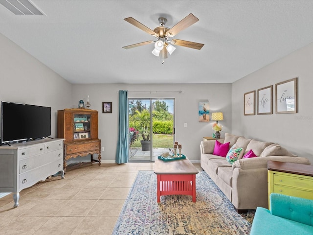 tiled living room with ceiling fan