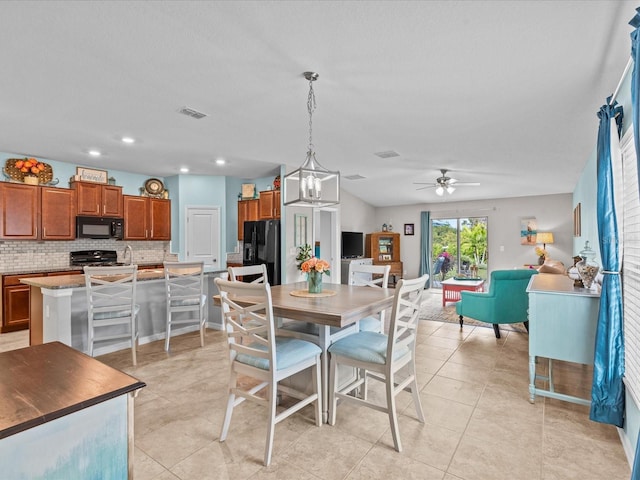 dining area featuring ceiling fan with notable chandelier and light tile patterned floors