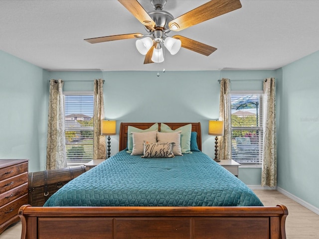 bedroom with light hardwood / wood-style flooring and ceiling fan