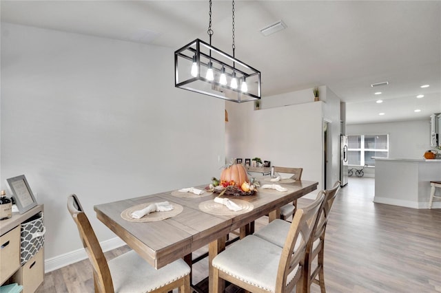 dining space with hardwood / wood-style floors