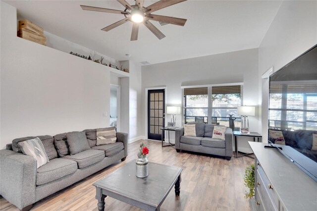 living room with ceiling fan and light hardwood / wood-style floors