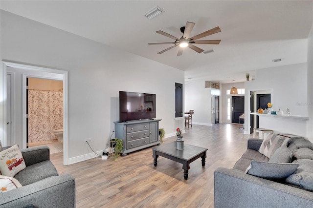 living room with ceiling fan and light wood-type flooring