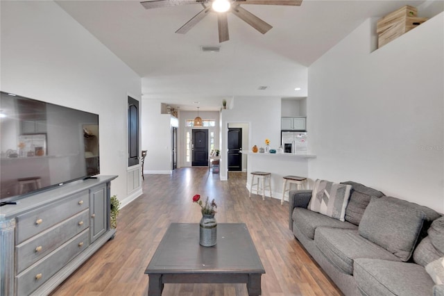 living room featuring hardwood / wood-style flooring and ceiling fan