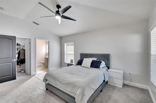 carpeted bedroom with lofted ceiling, ensuite bathroom, ceiling fan, a spacious closet, and a closet