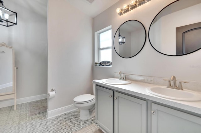 bathroom with tile patterned flooring, vanity, toilet, and vaulted ceiling