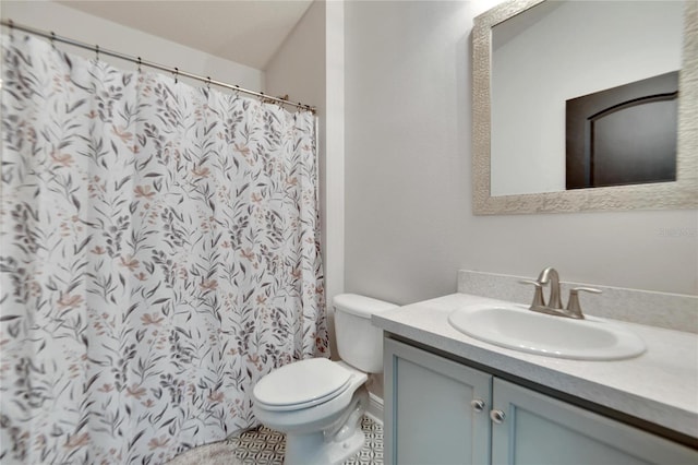 bathroom featuring tile patterned flooring, vanity, and toilet