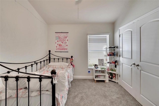 carpeted bedroom featuring lofted ceiling