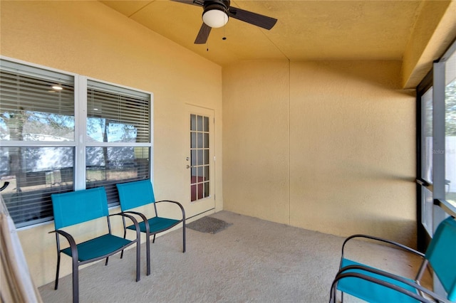 sunroom with ceiling fan and vaulted ceiling