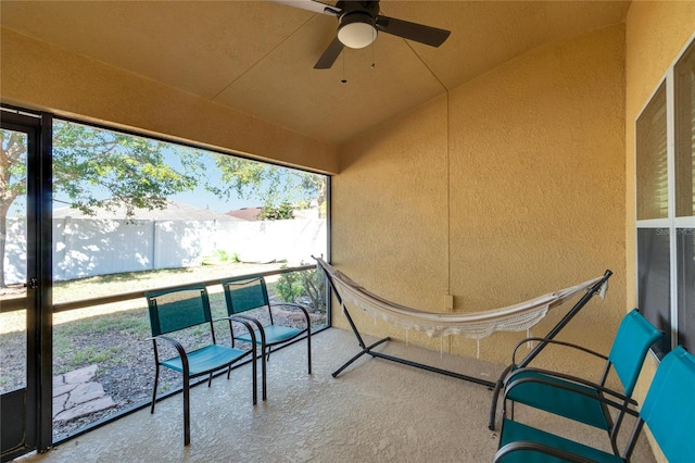 sunroom / solarium featuring ceiling fan and lofted ceiling