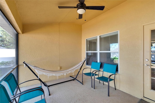 sunroom with ceiling fan and lofted ceiling