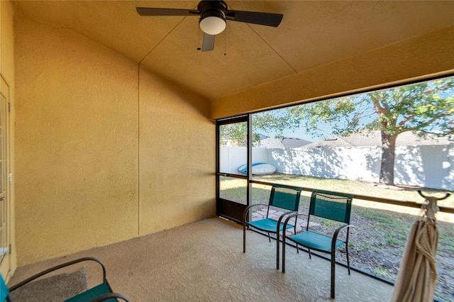 sunroom featuring ceiling fan and vaulted ceiling