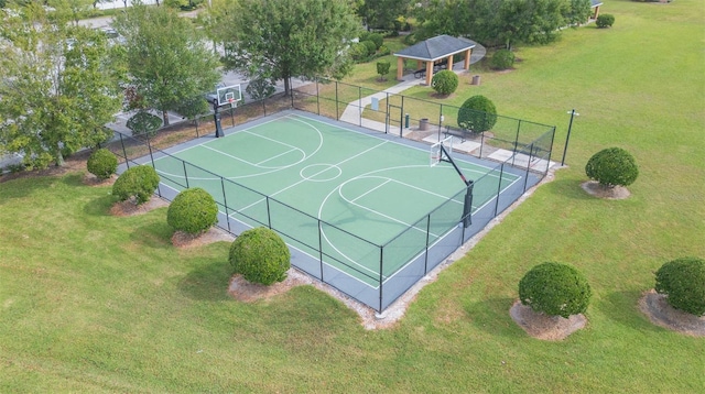 view of sport court with a yard