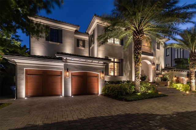 view of front of home featuring a balcony and a garage