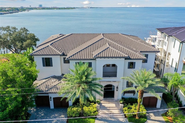 view of front of house featuring a water view and a balcony