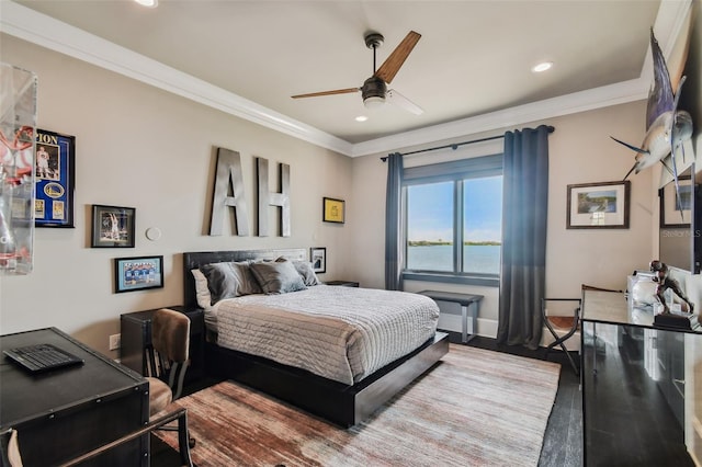 bedroom featuring hardwood / wood-style flooring, ceiling fan, and crown molding