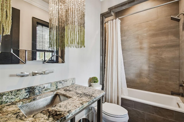 full bathroom with vanity, toilet, shower / bath combo with shower curtain, and crown molding