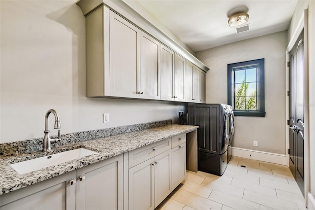 clothes washing area featuring cabinets, sink, and hookup for a washing machine