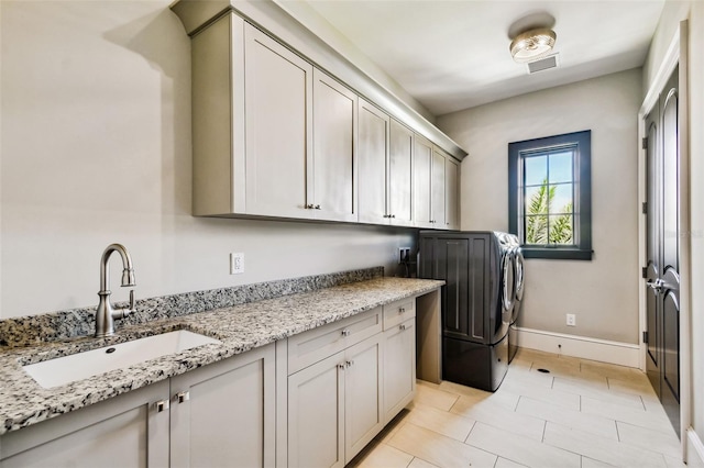 5120 W Longfellow Ave, Tampa, FL 33629 - laundry room featuring cabinet space, baseboards, and washer and dryer