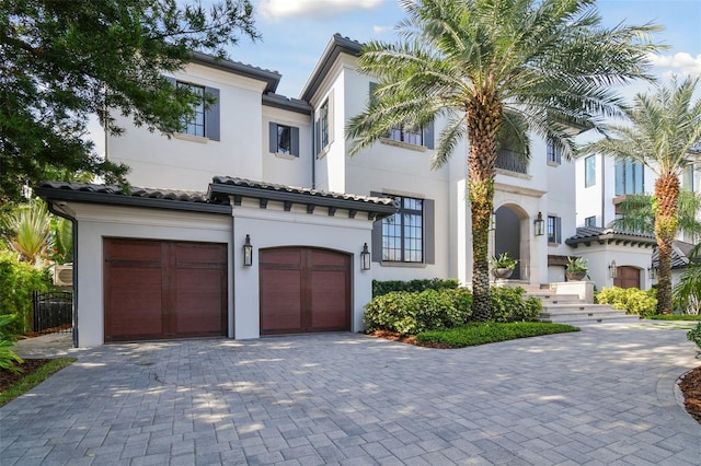 mediterranean / spanish home featuring a garage