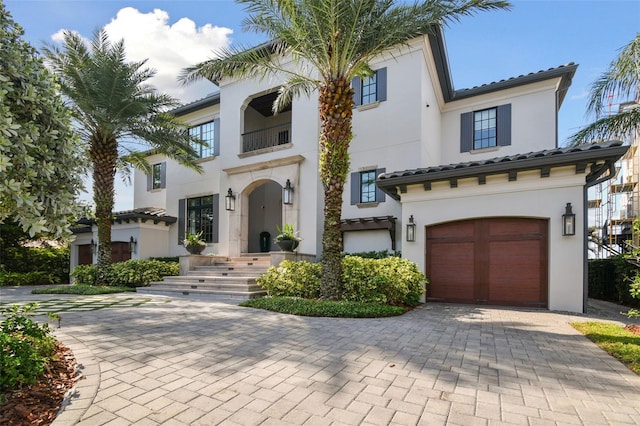 mediterranean / spanish-style house with a garage