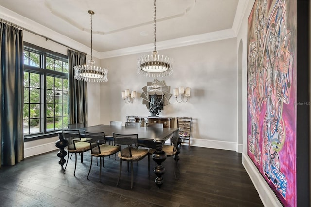 dining space with crown molding, dark wood-type flooring, and an inviting chandelier