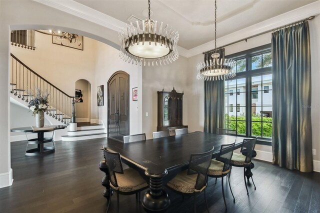 5120 W Longfellow Ave, Tampa, FL 33629 - dining area featuring a chandelier, arched walkways, dark wood-style floors, healthy amount of natural light, and a towering ceiling