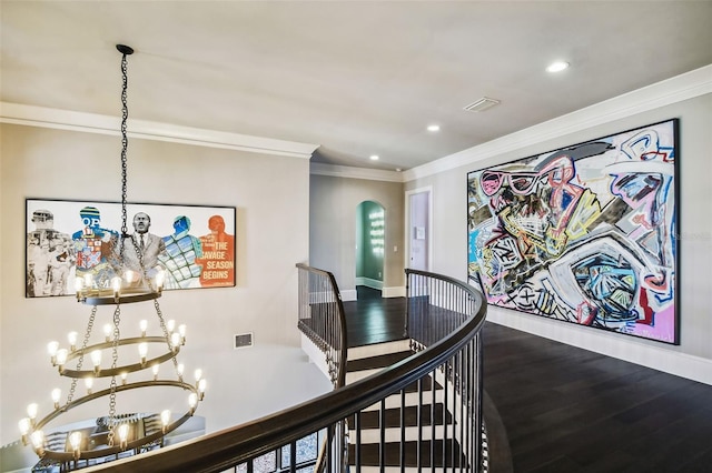 hallway featuring a chandelier, hardwood / wood-style floors, and ornamental molding