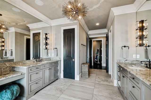 bathroom with an inviting chandelier, vanity, and ornamental molding