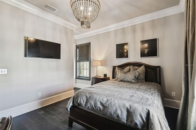 bedroom featuring ornamental molding, dark wood-type flooring, and a notable chandelier