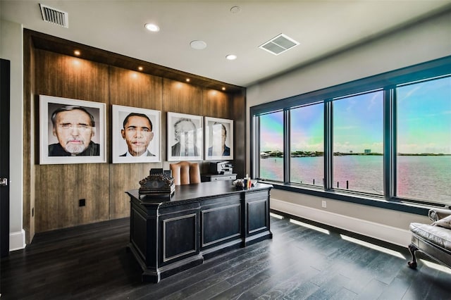 office area featuring a water view and dark wood-type flooring