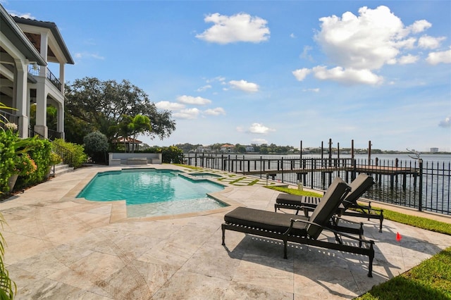 view of swimming pool featuring a patio area and a water view