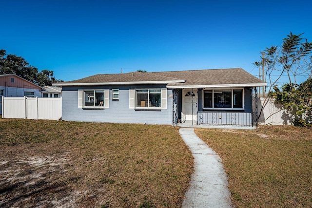 single story home with a front yard and covered porch