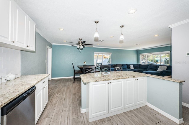 kitchen featuring pendant lighting, white cabinets, stainless steel dishwasher, and ornamental molding