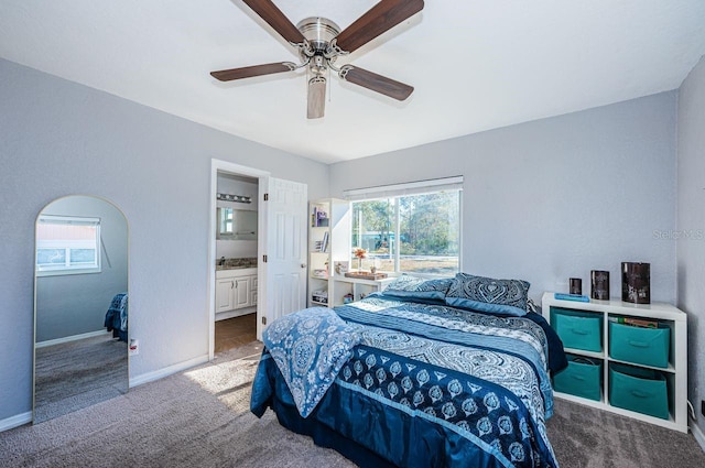 bedroom with carpet flooring, ensuite bath, ceiling fan, and sink