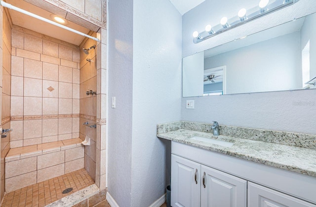 bathroom featuring vanity and tiled shower