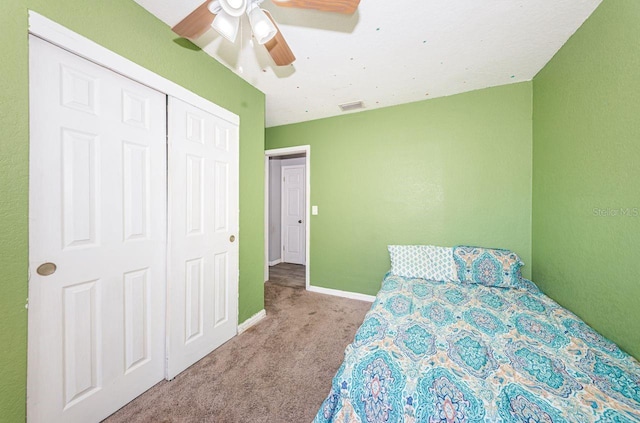 bedroom featuring ceiling fan, a closet, and light carpet