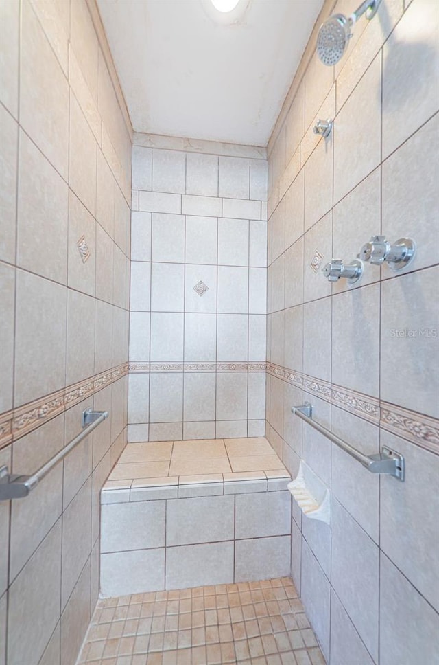 bathroom with tiled shower