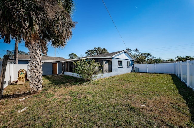 back of house with a lawn