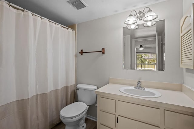 bathroom featuring vanity, toilet, and ceiling fan