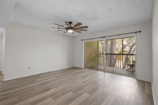 unfurnished room with ceiling fan, a textured ceiling, and hardwood / wood-style flooring