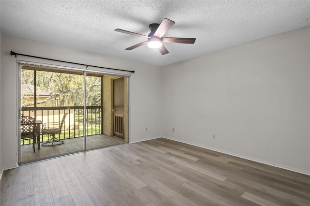 empty room with wood-type flooring, a textured ceiling, and ceiling fan