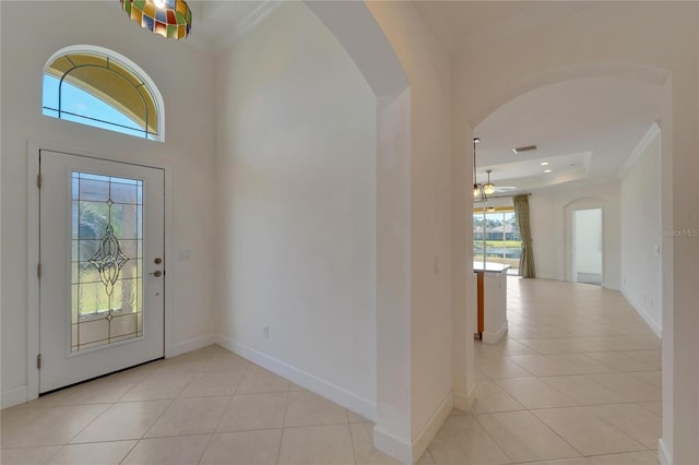 entryway featuring ceiling fan, light tile patterned floors, and a wealth of natural light