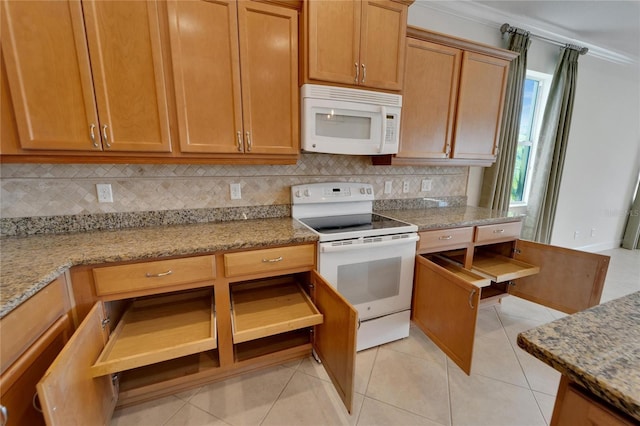 kitchen with light stone counters, white appliances, and light tile patterned floors