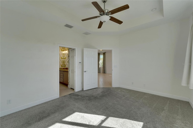 spare room with light colored carpet and ceiling fan