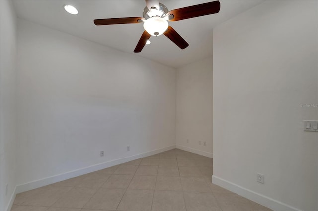 tiled empty room featuring ceiling fan