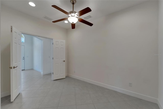 tiled empty room with ceiling fan